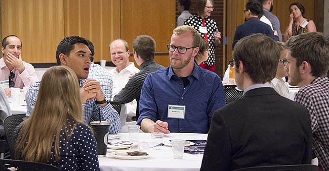 Alumnus Michael Azuma (Sun Chemical) talks to panelists and students during the networking portion.