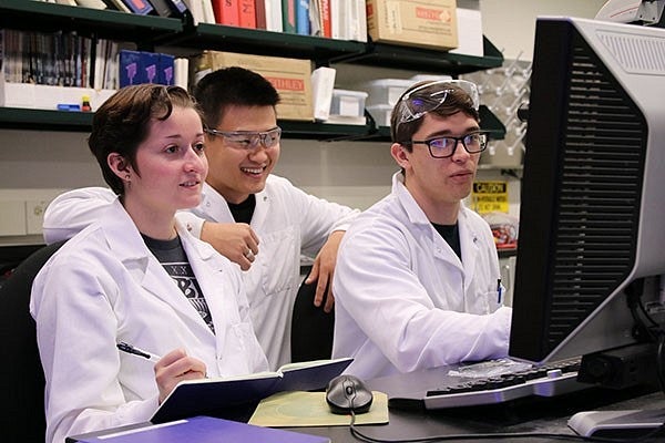 Students work together at computer