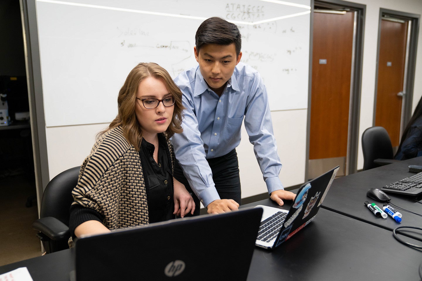 Two people working together on a computer