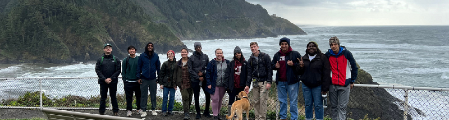 Students standing by the ocean