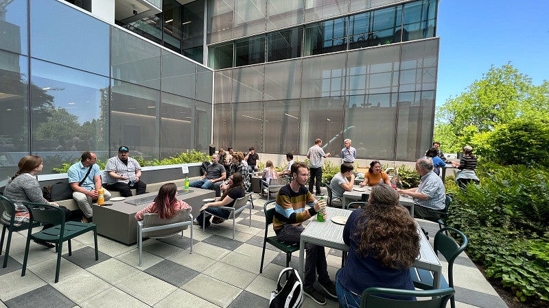 Group of students eating lunch and having conversation on the Knight Campus Terrace