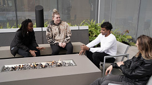 Master's students chatting on terrace