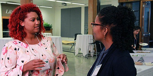 Alumnae Mikaela Hall (Emerald Performance Materials) chats with Takiya Ahmed Foskey, a panelist from Dow.