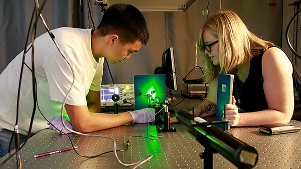 students experimenting with laser
