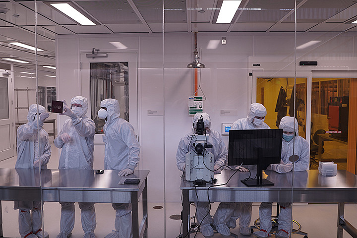 People in PPE gear in a clean room